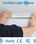 Hands installing Pack Of 4 Linkable LED Shop Lights For Garage And Basement 6 Foot Long 60W T8 Integrated Ceiling Light