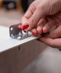 Close-up of hands installing bolt from 113 Piece Bolts Nuts And Washers Assortment Kit Galvanized Iron Hardware Set For Home Repair