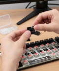 Hands installing 200 Pieces O Ring Keyboard Dampeners For MX Switches And Mechanical Keys, Clear Rubber Dampeners on keyboard