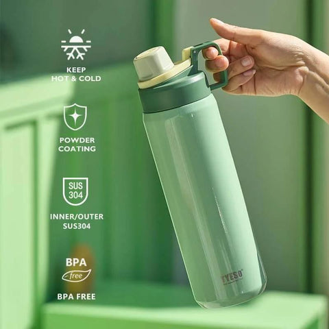 Hand holding insulated stainless steel water bottle with spout lid and easy grip handle for sports on the go, green color.