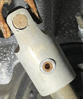 Close-up of installed Premium Engraved 6061 Billet Intermediate Shaft Bushing on Dodge Ram steering system.