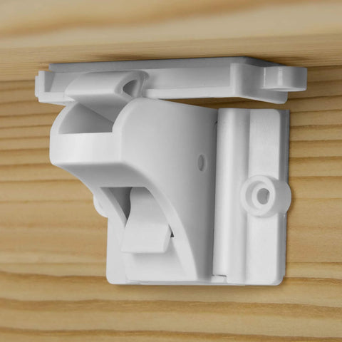 Keep curious kids safe with invisible magnetic cabinet locks that install quickly with 3M adhesive, shown inside wooden cabinet