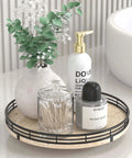 Italian natural travertine lazy susan turntable for table top with black frame holding a vase and bath products.