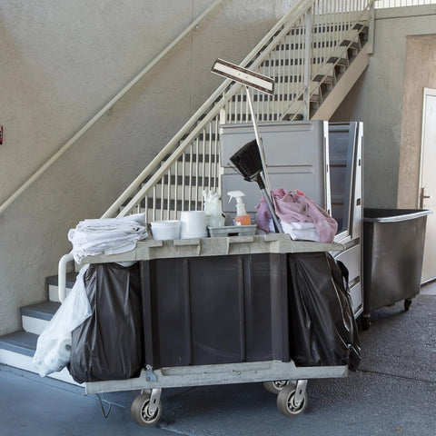 Industrial cleaning cart with supplies on heavy duty caster wheels set of 4 6x2 flat tread rubber casters near stairs