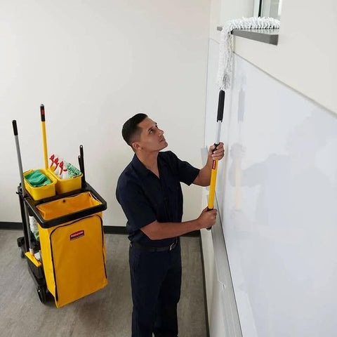 Janitor with cleaning cart, featuring Heavy Duty 24 Gallon Front Zippered Vinyl Replacement Bag For Industrial Janitorial Carts Yellow Waste Linen And Trash Collection Durable Front Loading Bag For Commercial Cleaning Compatible With Rubbermaid Commercial Carts, mopping window in office.