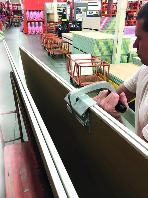 JawClaw Panel Gripper for Plywood, Drywall and Steel Sheets in use, showing secure handling and stable alignment in store setting.