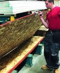 Man using ✝️ JawClaw Panel Gripper for Plywood, Drywall and Steel Sheets in workshop, ensuring smooth motion and alignment.