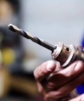 Person holding a drill with KFD Series High Speed Steel Drill Bits Split Point One Eighth Inch Pack Of 12 For General Purpose Drilling