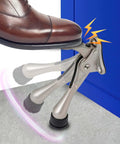Foot activating One Touch Kickdown Door Stopper, satin nickel finish with height-adjustable rubber tips by HASHI, keeping door open.