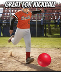 Child kicking a red ball on a baseball field, perfect for 10 Inch Kickball Playground Balls - (Pack of 6) Inflatable Rubber Indoor Outdoor Bouncy Balls for Adults & Kids - Dodgeballs, Kickballs, Four Square and Handballs for School, Gym, with Hand Pump.