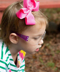 Child wearing Kids Safety Glasses ANSI Z87.1 EN166 Certified Impact Resistant Clear Lenses with pink bow, side view