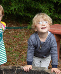 Children wearing Kids Safety Glasses ANSI Z87.1 EN166 Certified Impact Resistant Clear Lenses playing outdoors