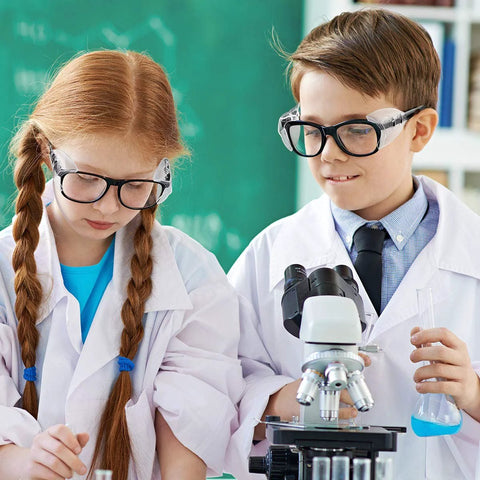 Children in lab coats wearing Two Pairs Side Shields For Glasses Slip On Eye Protection Fits Most Eyewear while working with a microscope.