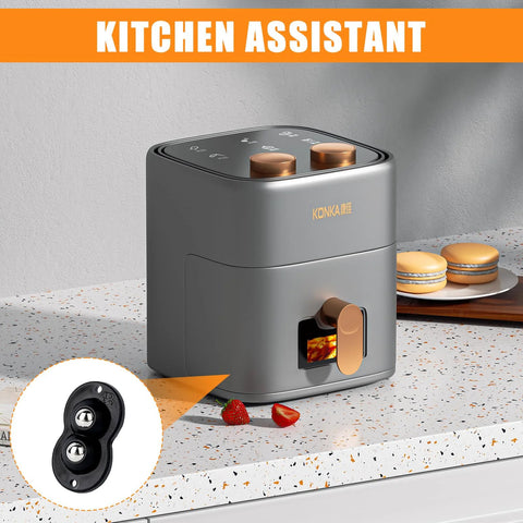 Grey kitchen appliance with toast slot on counter, orange accents, "KITCHEN ASSISTANT" text, black caster wheel inset