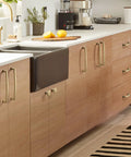 Champagne Bronze 10 Pack Cabinet Knobs Single Hole Drawer Pulls for Kitchen and Bedroom Cabinets shown on wooden cabinets