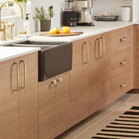 Champagne Bronze 10 Pack Cabinet Knobs Single Hole Drawer Pulls for Kitchen and Bedroom Cabinets shown on wooden cabinets