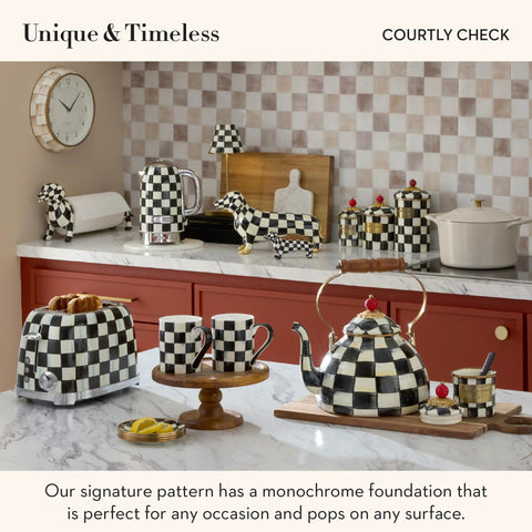 Kitchen countertop with checkered teapot, toaster, condiment jars, and cutting board in Mackenzie-Childs Courtly Check pattern.