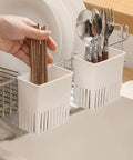 Cutlery Drying Rack - Utensil Drainer - Cutlery Drainer for Sink with chopsticks and silverware in kitchen holder next to sink.