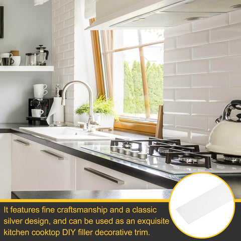 Kitchen with stainless steel appliances and white brick backsplash, featuring DIY filler trim for decorative edging.