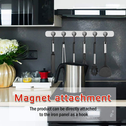 Magnetic utensil holder with hooks attached to kitchen wall above stove.