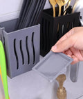 Person using Multifunctional Kitchen Utensil Rack Draining Chopstick Holder Wall-Mounted Freestanding Cutlery Storage Box (Black)