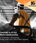 Worker in safety vest holding railing in an industrial facility, promoting protection gear from KleenGuard.