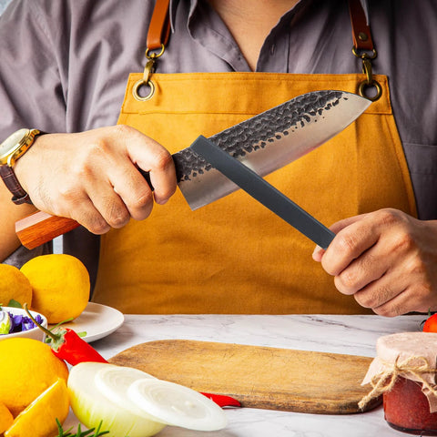 Person sharpening a knife with a Flat 6 Inch Hand File With Double Cut Teeth And Single Cut Edge Made From High Carbon Steel