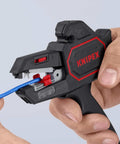 Person using Knipex Automatic Wire Stripper 10-24 AWG, 7.25 Inch Length for precision insulation stripping on blue wire.