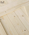 Close-up of unfinished knotty barn door, 34x84 inches, made of solid spruce with natural wood grain, ready to stain or paint.