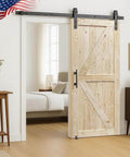 Unfinished 34 In By 84 In Knotty British Brace Barn Door With 6.6 Ft Sliding Hardware Kit installed in a modern interior
