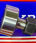 Side view of KR32 32mm Cam Follower Needle Roller Bearing on blue background