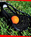 Close-up of a lacrosse stick head with an orange ball on grass, highlighting Velocity branding.
