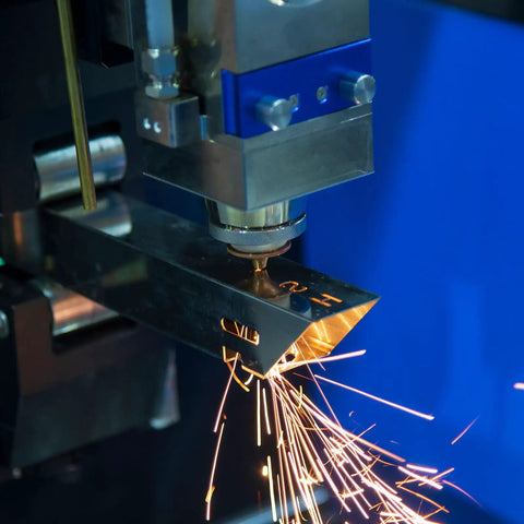 Machine cutting metal with sparks, showcasing industrial metalworking process in action