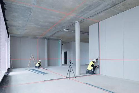Workers using clear room layout fast with a 360 degree three plane laser delivering bright alignment lines in a construction site.