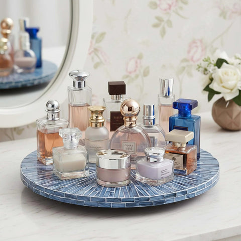 12.6 inch mother of pearl lazy susan turntable with blue starburst design holding various perfumes on countertop.