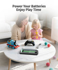 12 Bay LCD Battery Charger for AA or AAA and 9V with 10 AA or AAA and 2 9V Slots on a table with toys and a remote control.