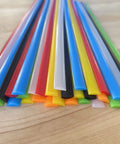 LDPE Plastic Welding Rods 7 Color Set For DIY PE Plastic Repair on wooden surface, showing flat rod ends in various colors