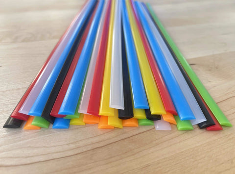 LDPE Plastic Welding Rods 7 Color Set For DIY PE Plastic Repair on wooden surface, showing flat rod ends in various colors