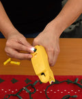 Person using The Complete LED Christmas Holiday Light Set Repair Tool to fix string lights on a table.
