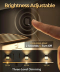 Close-up of a finger adjusting brightness on a Two Pack Led Night Light Plug In With Dusk To Dawn Sensor Three Level Brightness 30 60 100 Lum