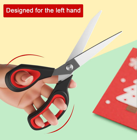 Heavy Duty All Purpose Fabric Scissors For Sewing And Garment Making With Stainless Steel Blades held in left hand next to craft paper