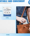 Person placing Premoistened Lens Cleaning Wipes For Glasses Phones And Cameras Pack Of 1000 into a brown bag, showing packaging size.