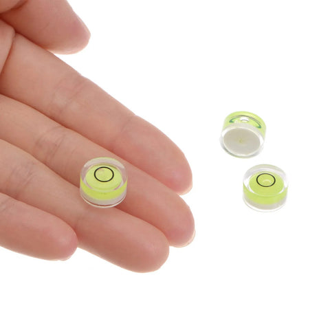 Close-up of Three Piece Round Bubble Level Set 12x6mm Mini Circular Bullseye Spirit Levels for leveling camera tripod telescopes.