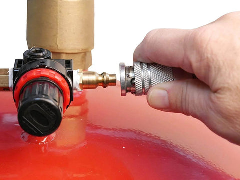 Close-up of hand connecting hose to Lincoln 3601 Pneumatic 18 Gallon Pressurized Fluid Drain and Evacuation Tank, red top visible.
