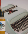 Liquid Bearings, SUPERIOR 100%-synthetic oil for lubrication of drones, RC vehicles, placed next to vintage typewriter
