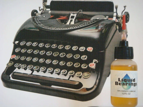 Image of Liquid Bearings, SUPERIOR 100%-synthetic oil bottle next to a vintage black typewriter for lubrication purposes.