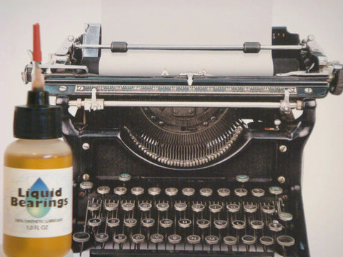 Liquid Bearings SUPERIOR 100%-synthetic oil bottle next to an antique typewriter for lubrication of drones, RC vehicles and equipment