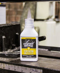LIQUID WRENCH PENETRATING OIL 4 OZ DROPPER on a metal industrial machine