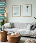 Living room with gray sofa, two wooden tables, decorative pillows, and green plants, highlighting bonding, connecting, mounting.