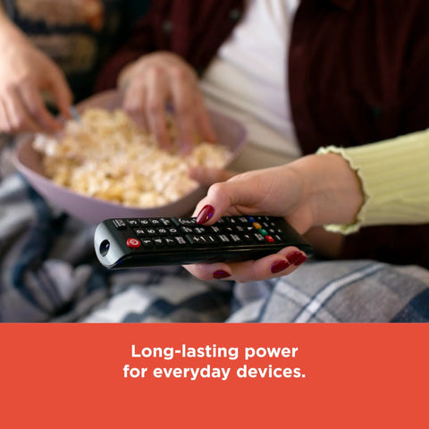 Couple watching TV with remote powered by Mixed Alkaline Battery Pack 12 AA 12 AAA With Reusable Plastic Case